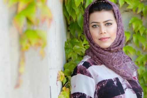 a woman from Saudi Arabia smiling at the camera